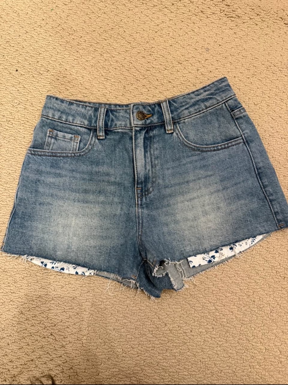 High-Rise Blue Denim Shorts with Frayed Hem and Floral Trim